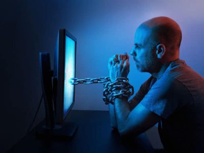 Man-chained-to-computer-screen